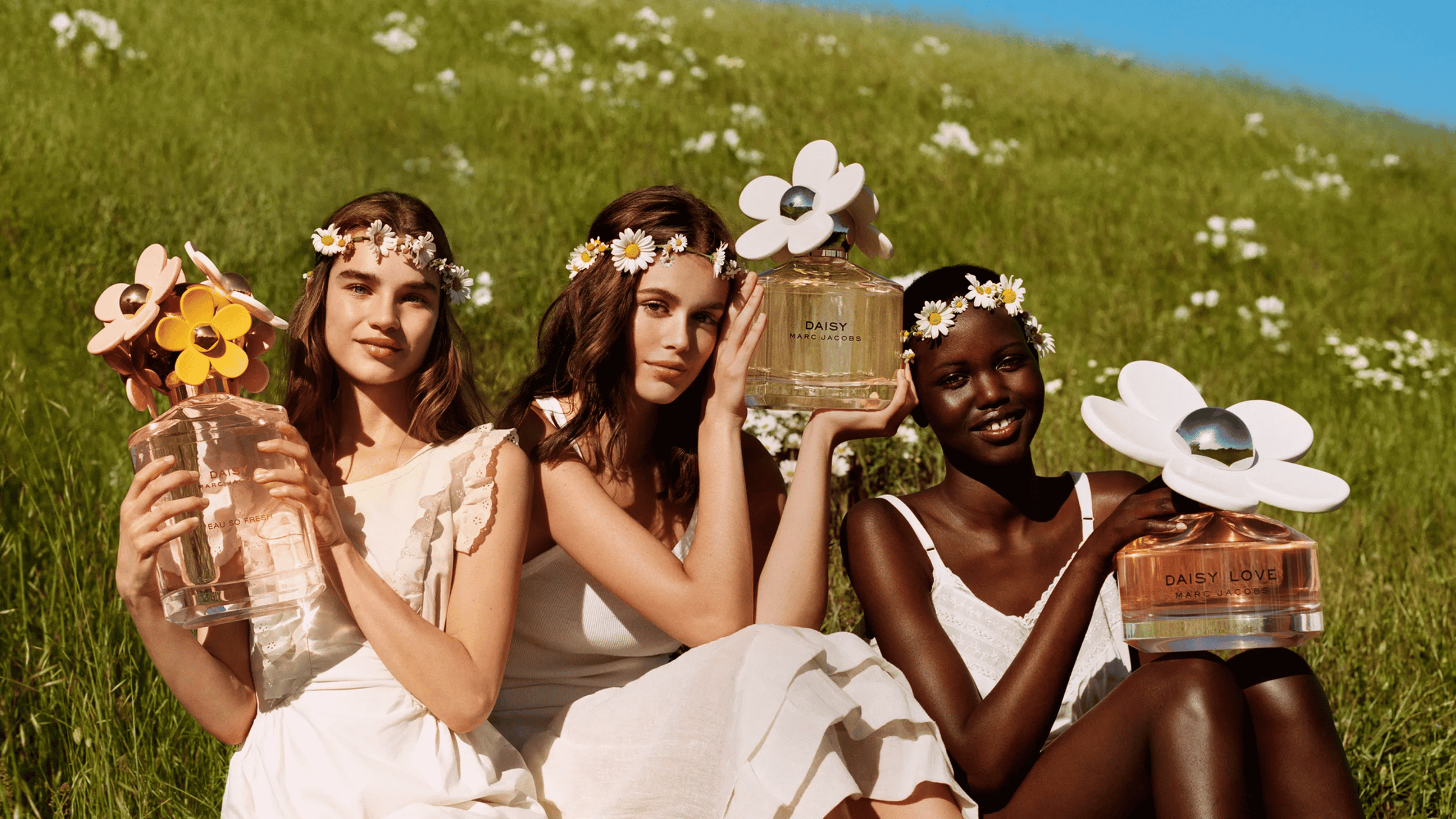 Tre tjejer som håller i varsin Marc Jacobs parfym